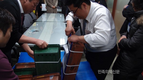 ◇서울시한의사회 사무국 직원들이 투표용지가 담긴 박스를 옮기고 있다. <김춘호 기자>